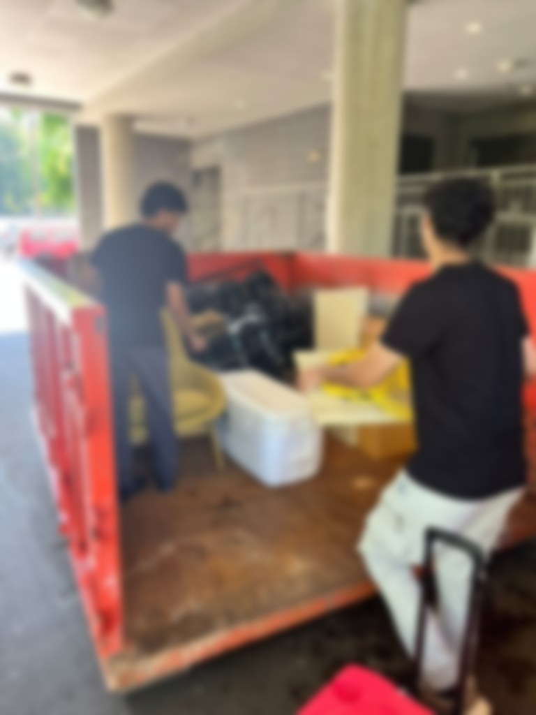 Crew clearing furniture out of a unit on a cleanout job